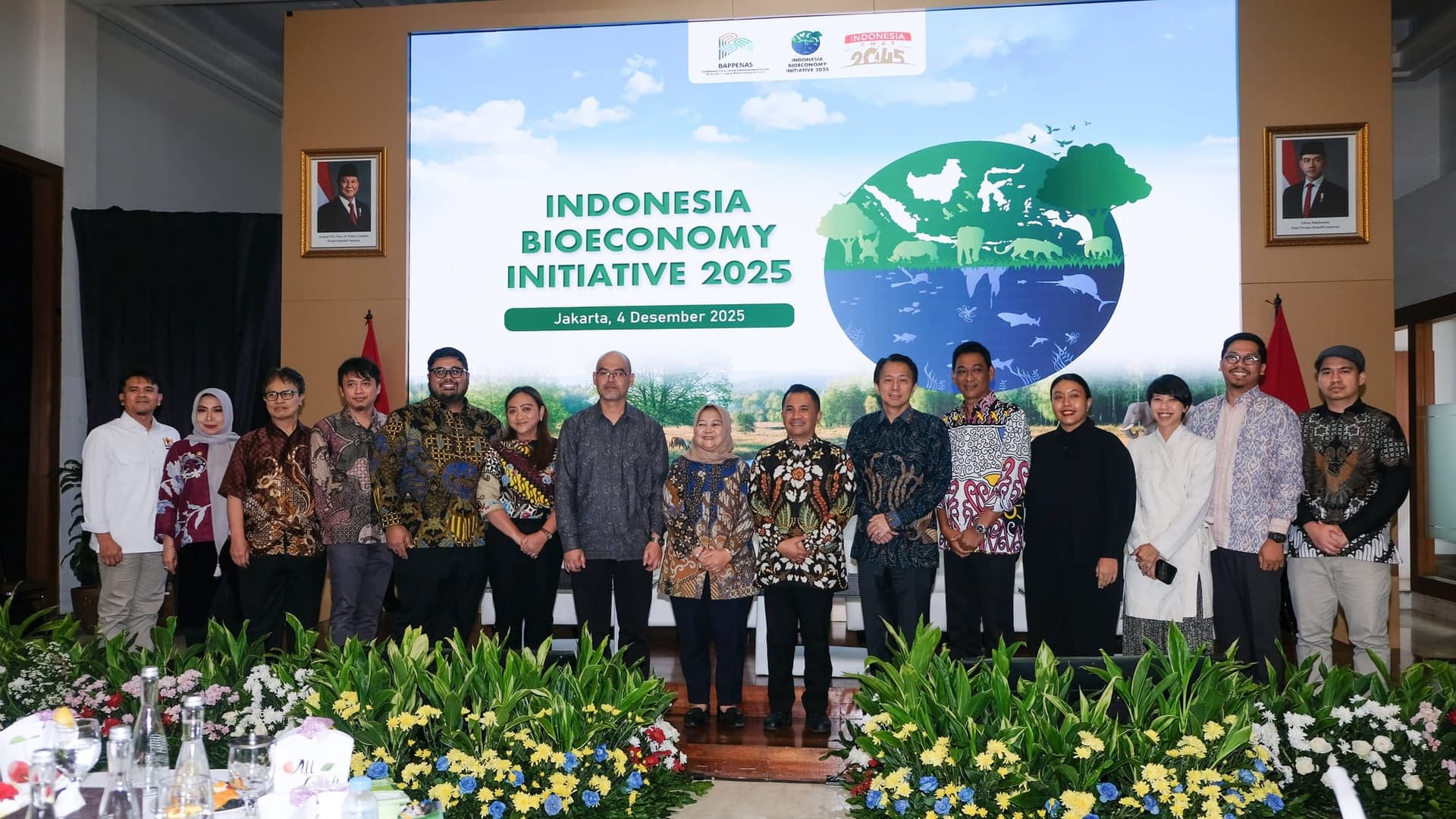 Deputies and panelists standing in front of the Indonesia Bioeconomy Initiative 2025 screen